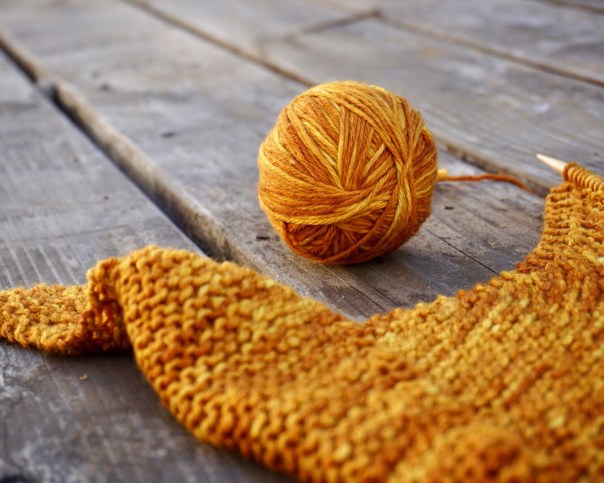 Onion dyed ball of yarn with knit shawl project